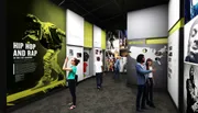 This image depicts visitors engaging with exhibits at a modern museum dedicated to the history and culture of hip hop and rap.