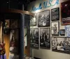The image shows an exhibit displaying memorabilia and images related to the Motown music genre and artists with Hitsville USA prominently featured on the wall