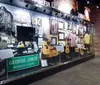 The image shows a museum display featuring memorabilia including guitars clothing and photographs dedicated to the legacy of a musician