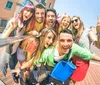 A group of cheerful young people are taking a selfie together on a sunny day