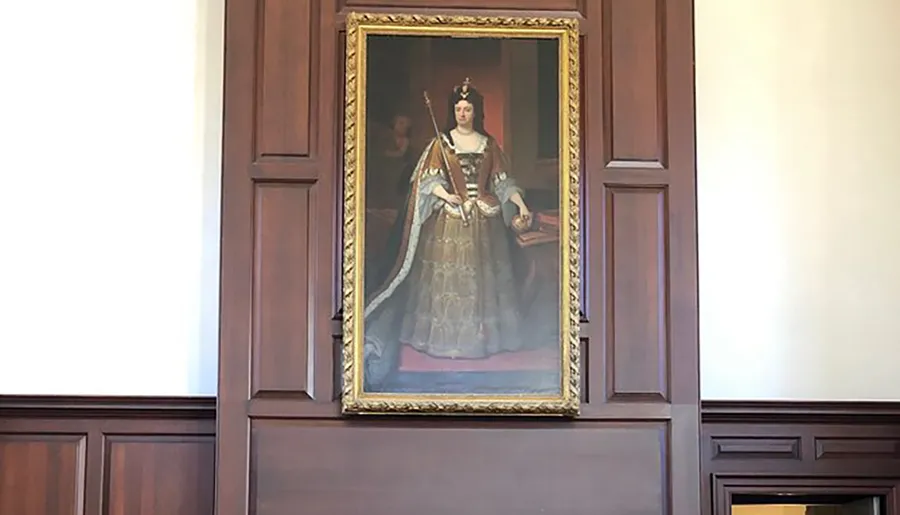 The image shows a regal portrait of a woman in royal attire with a crown and scepter, displayed prominently over a mantelpiece in a room with wood paneling.
