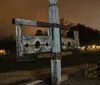 An old wooden pillory stands ominously in nightfall perhaps a historic relic or a reproduction typically used in the past for public humiliation and punishment