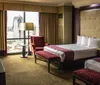 The image depicts a spacious and well-appointed hotel room with a large bed inviting decor and a view of the city skyline through the window