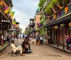 Street musicians perform on a vibrant bustling street adorned with colorful Mardi Gras decorations characteristic of New Orleans famous French Quarter