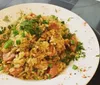 The image shows a plate of fried rice garnished with chopped green onions