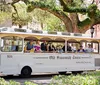 This image features a collage of tourist attractions in Savannah Georgia including a riverboat a historic building a trolley tour and a statue promoting the Tour Pass Savannah
