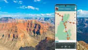 A mobile phone with a map application on its screen is superimposed on a scenic view of the Grand Canyon.