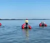 Several people are enjoying a sunny day on the water with their inflatable boats