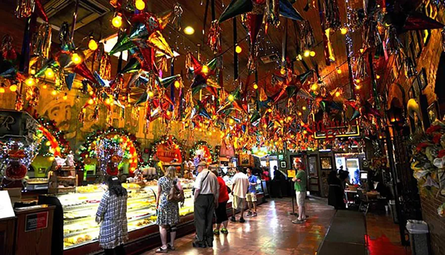 This image depicts a lively and colorful indoor market or restaurant, adorned with numerous festive decorations and patrons browsing or queuing for service.