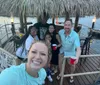 A group of cheerful people posing for a selfie on a tiki-themed boat bar