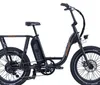 The image shows a modern electric bike with fat tires parked in a lush green area