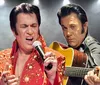 The image shows two performers one singing into a microphone and the other playing a guitar both dressed in costumes reminiscent of the style associated with Elvis Presley