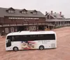 A tour bus branded Mt Rushmore Tours is parked in front of a rustic building with a sign that reads Chuckwagon Supper  Show