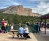 The image shows the iconic Mount Rushmore National Memorial featuring the carved granite faces of four former US presidents