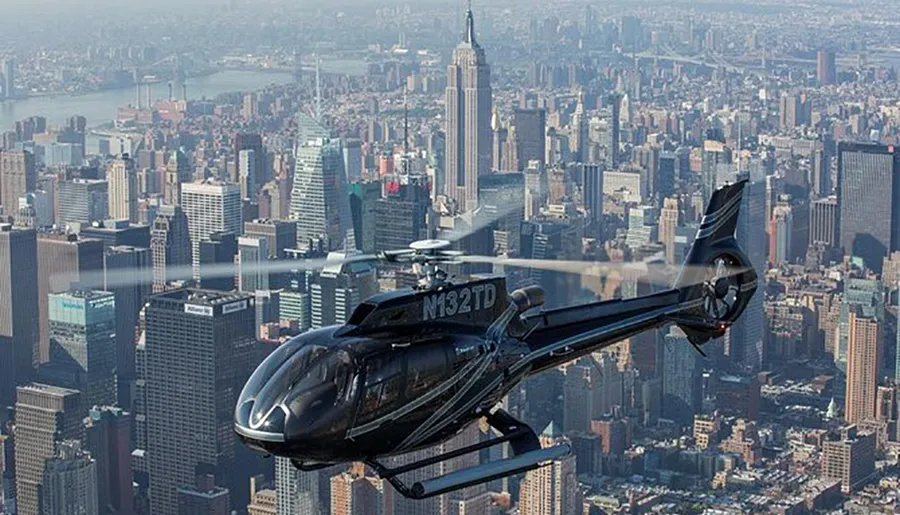 A helicopter is flying over a bustling cityscape with skyscrapers in the background.