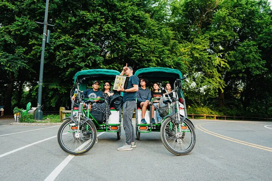 A group of people are enjoying a ride in pedal-powered rickshaws, with one person standing and reading a map.
