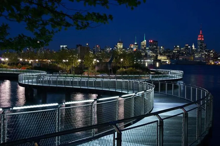 The image showcases a serpentine walkway along a waterfront at twilight with a vibrant city skyline illuminated in the background.