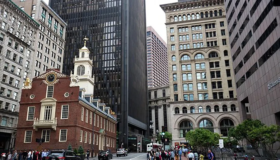 The image shows a mix of historic and modern architecture with people walking in a city street.