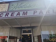 The image shows the entrance to Holsten's, an ice cream parlor with signage that includes words like 
