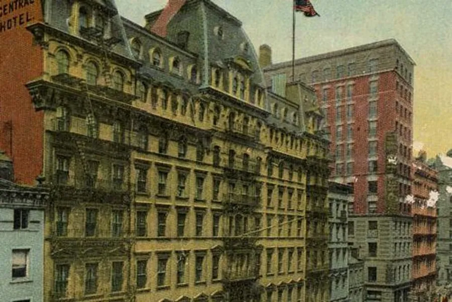 The image shows a colorful, vintage postcard of a bustling street corner with historical buildings, including the prominent Fifth Avenue Hotel in a city setting.