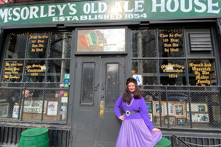 A person in a purple outfit is posing in front of McSorley's Old Ale House, an establishment dating back to 1854.