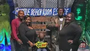 A group of people is celebrating their successful escape from a room escape challenge at Myrtle Beach Room Escape, with a child holding a 