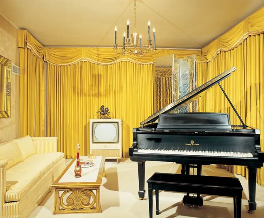 The image features an opulent room dominated by yellow hues, with grand curtains, a chandelier, a black grand piano, a vintage television, and elegant furniture.