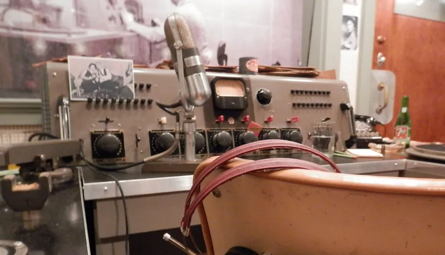 The image displays a vintage ham radio setup complete with an old-fashioned microphone, various tuning equipment, and a visual aesthetic reminiscent of mid-20th-century communications technology.
