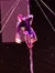 A performer is skillfully climbing a pole on a stage with a starry backdrop.