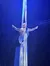 A performer is suspended in mid-air, wrapped in aerial silks against a starry backdrop, exuding an aura of triumph and grace.