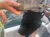 A person is holding a fish on a boat, with water visible in the background.