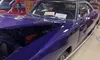 A purple classic car with a 