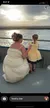 A woman and a child in dresses are gazing at the sunset over a body of water from a boat.