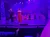 Performers are singing on a stage with a festive, winter-themed backdrop.