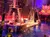 Performers engage in a pirate-themed show on a ship set in front of an audience, creating an immersive theatrical experience.