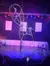 Performers execute a dramatic act with large rotating rings in a live stage show, captivating the audience.