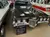 The image shows a 1969 Pontiac Grand Prix Model J displayed in a vintage car collection with a descriptive sign, surrounded by other classic vehicles and decorative hubcaps on the walls.