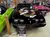The image shows a black 1979 Pontiac Trans Am on display in a vintage car showroom filled with memorabilia and other classic cars.