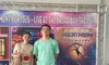 Two people are standing in front of a colorful poster for upcoming 2026 performances at the Broadway Theater.