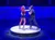 Two performers on roller skates are dancing energetically on a circular platform under stage lights.