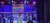 Musicians and singers perform on stage under a