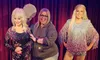 A person is posing with two lifelike wax figures of celebrities on a stage with a red curtain backdrop.