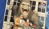 The image shows a group of people smiling and posing in front of a colossal gorilla display at the Hollywood Wax Museum in Pigeon Forge.