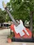 A large, decorative red and white guitar sculpture with