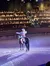 A performer on horseback is saluting the audience in an indoor arena.
