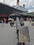 This image shows visitors near a large replica of the Titanic's anchor in front of a building designed to resemble the ship, complete with the White Star Line logo.
