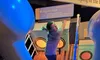 A person is struggling to climb a slanted deck, simulating a 45-degree slope, at an educational exhibit about the sinking of a ship.