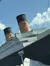 The image captures a partial view of a large ship resembling the famous RMS Titanic, including its distinctive funnels, against a sunny sky with a bit of an iceberg visible at the bottom, likely part of a themed exhibit or attraction.