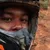 A group of people are enjoying an off-road adventure on ATVs in a forested area, with one of them taking a selfie.