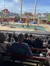 Spectators are watching a live outdoor performance where performers appear to be engaging in a water-based stunt or show.
